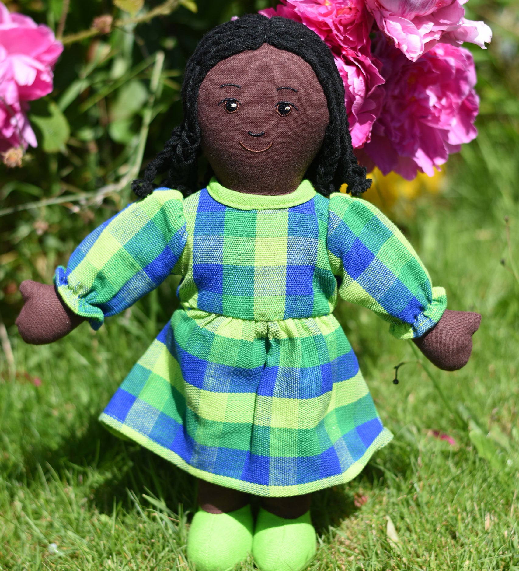 A Lanka Kade Rag Doll Mum with Black Skin, Black Hair. The doll is wearing a dress made from off cuts of sari material. 