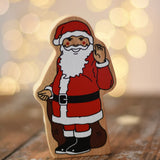 Lanka Kade Father Christmas wooden wooden toy figure placed on a wooden surface in the Babipur playroom. 