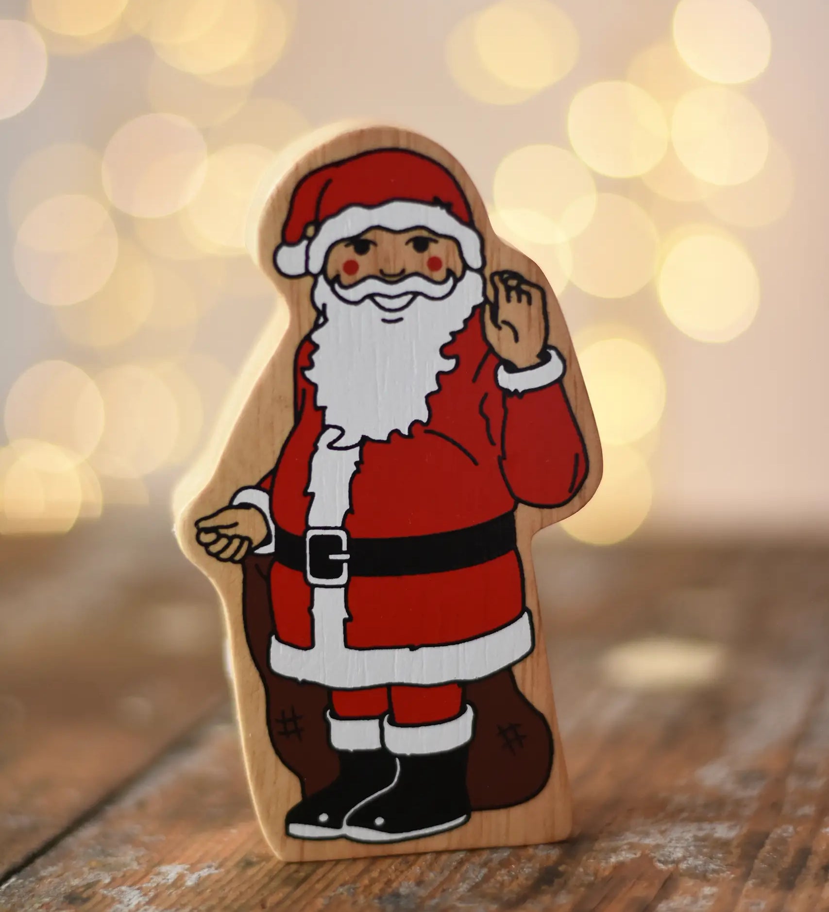 Lanka Kade Father Christmas wooden wooden toy figure placed on a wooden surface in the Babipur playroom. 