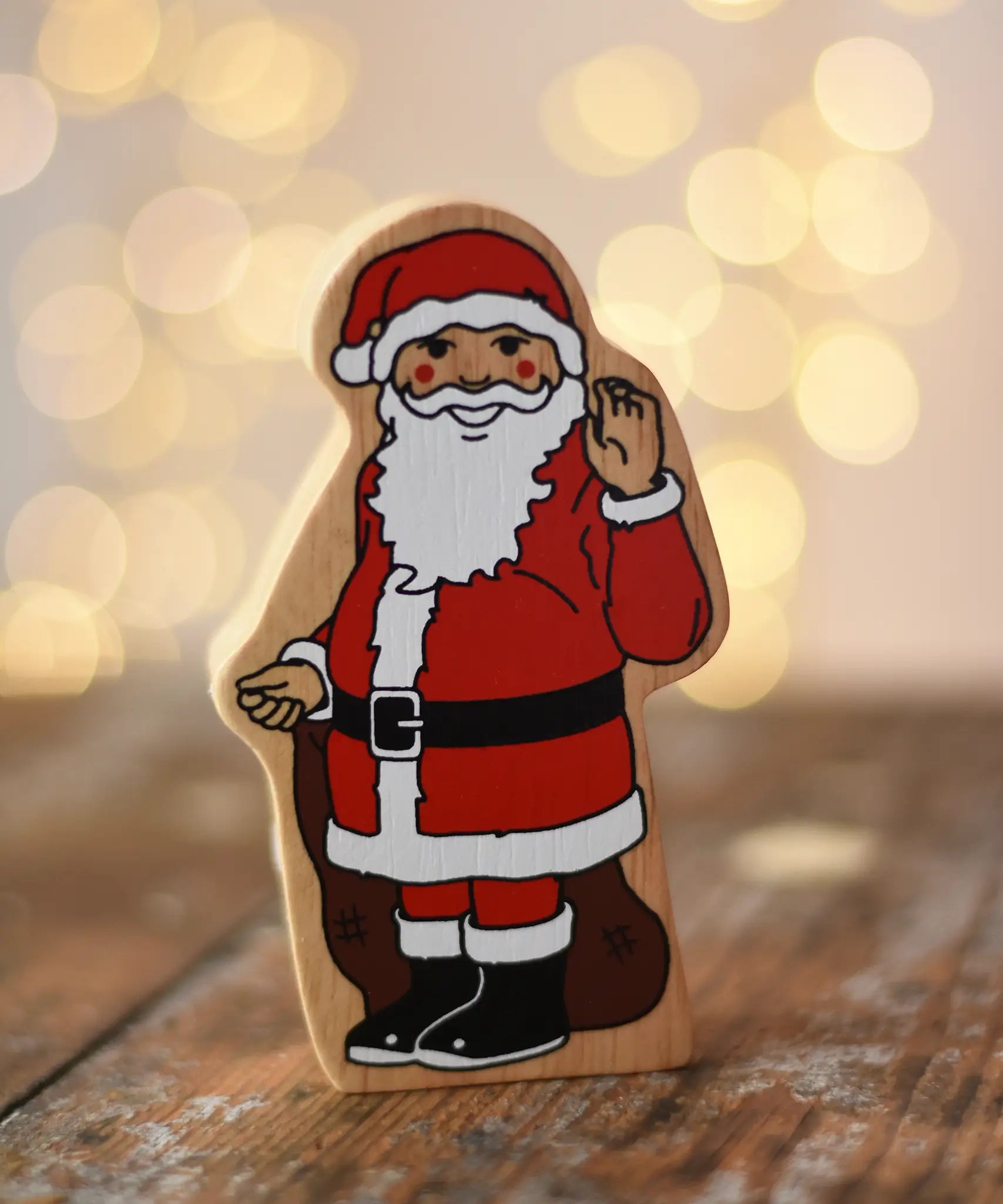 Lanka Kade Father Christmas wooden wooden toy figure placed on a wooden surface in the Babipur playroom. 
