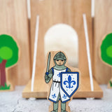 Lanka Kade wooden blue front facing knight figure standing in front of a wooden castle