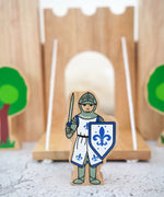 Lanka Kade wooden blue front facing knight figure standing in front of a wooden castle