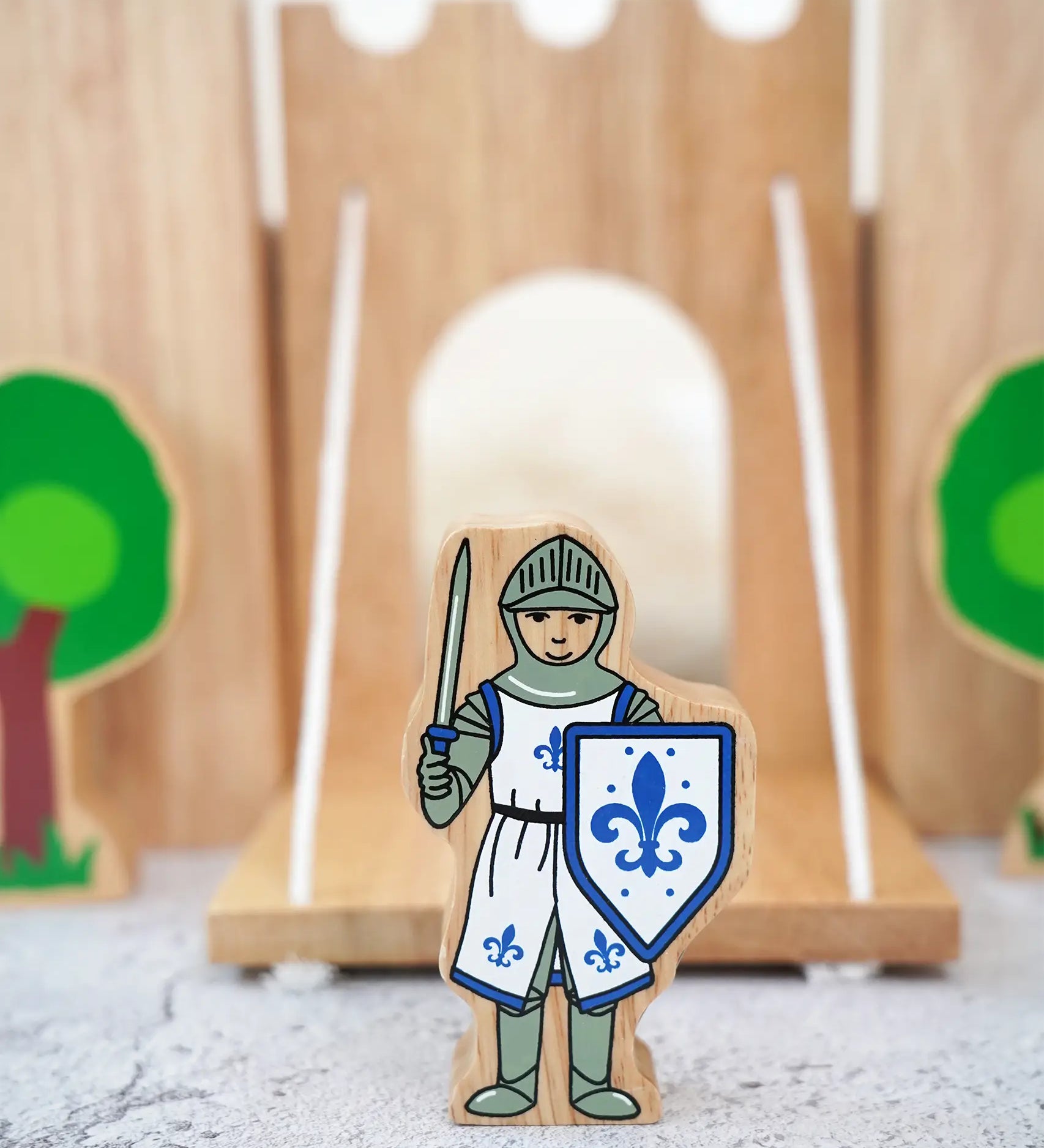 Lanka Kade wooden blue front facing knight figure standing in front of a wooden castle