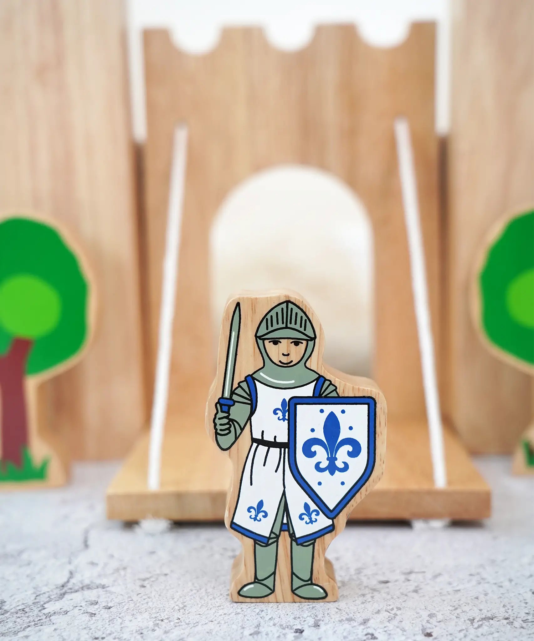 Lanka Kade wooden blue front facing knight figure standing in front of a wooden castle