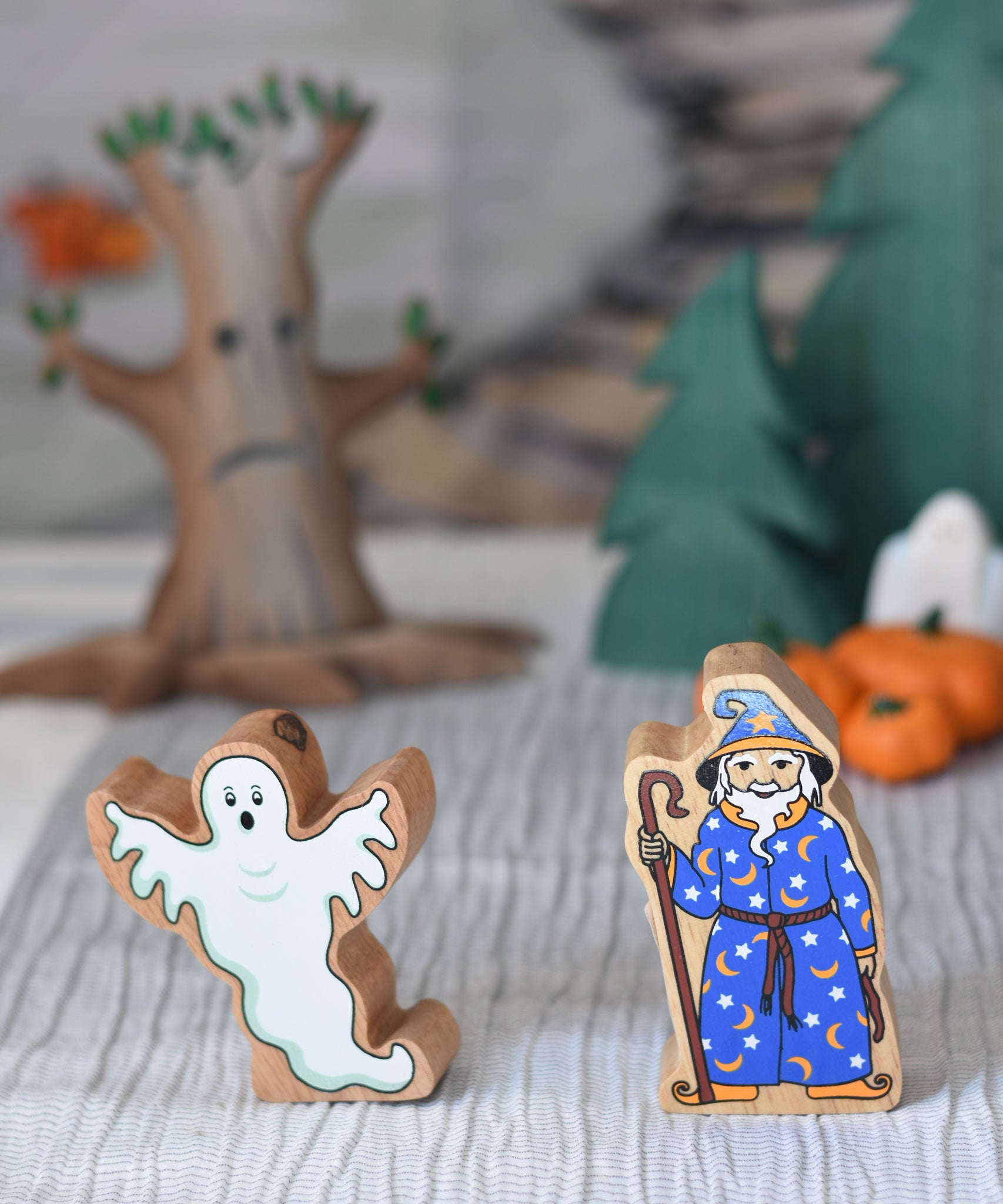 A Lanka Kade ghost and wizard toy figures placed at the front of a small world play scene.