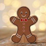 Lanka Kade gingerbread man wooden toy figure placed on a wooden surface in the Babipur playroom.