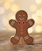 Lanka Kade gingerbread man wooden toy figure placed on a wooden surface in the Babipur playroom.