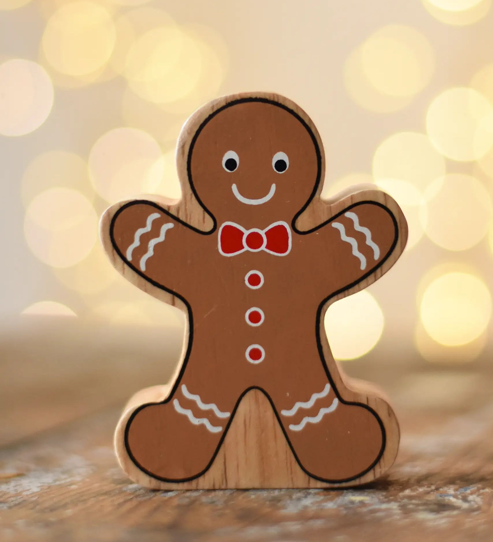 Lanka Kade gingerbread man wooden toy figure placed on a wooden surface in the Babipur playroom.