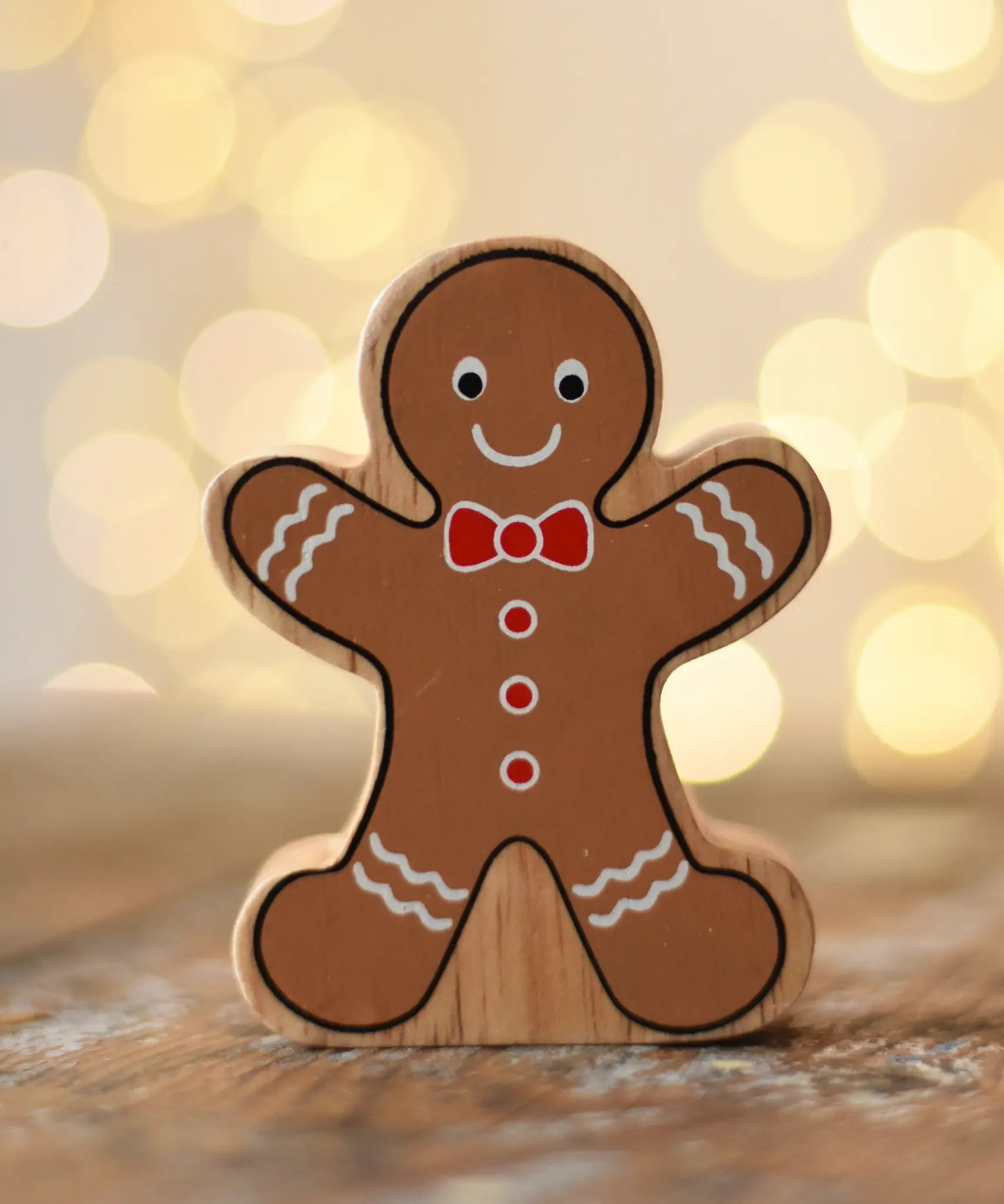Lanka Kade gingerbread man wooden toy figure placed on a wooden surface in the Babipur playroom.