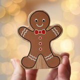 Lanka Kade gingerbread man wooden toy figure in an adult's hand.