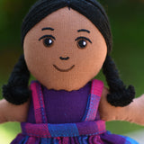 A close up of the face of the Lanka Kade Girl Doll with Brown Skin and Black Hair.