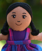 A close up of the face of the Lanka Kade Girl Doll with Brown Skin and Black Hair.