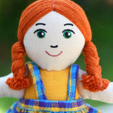 A close up of the face of the Lanka Kade Girl Doll with White Skin and Red Hair.