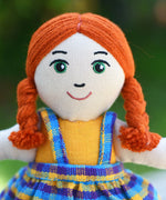 A close up of the face of the Lanka Kade Girl Doll with White Skin and Red Hair.