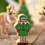 Lanka Kade Christmas elf wooden toy figure. Green outfit and hat with red and white striped leggings.