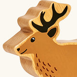 Close up of painted facial features on the Lanka Kade light brown stag wooden toy figure.