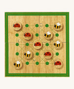 Lanka Kade minibeast wooden board game. A wooden square board game with a decorative green border. Set is made up from 4 jigsaw pieces with 5 lady bird and bee circular counters.
