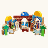 A wooden toy Lanka Kade nativity featuring painted blocks, arches, stable, palm trees, animals, and figures representing the Holy Family, Wise Men, and shepherds.