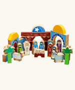 A wooden toy Lanka Kade nativity featuring painted blocks, arches, stable, palm trees, animals, and figures representing the Holy Family, Wise Men, and shepherds.