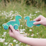 Lanka Kade Nessie push-along and Nessie wooden toy figure in a child's hands.