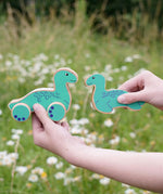 Lanka Kade Nessie push-along and Nessie wooden toy figure in a child's hands.
