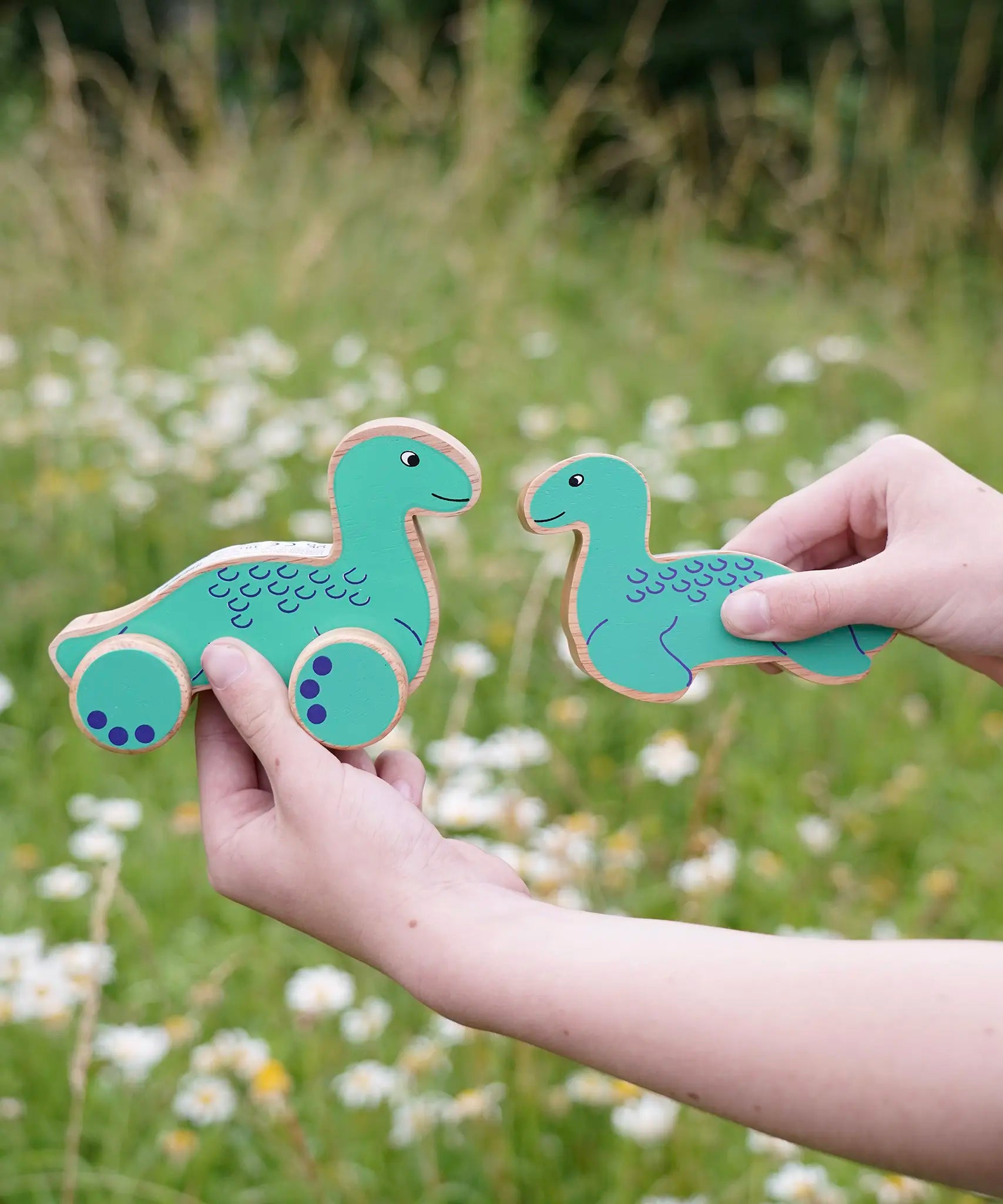 Lanka Kade Nessie push-along and Nessie wooden toy figure in a child's hands.