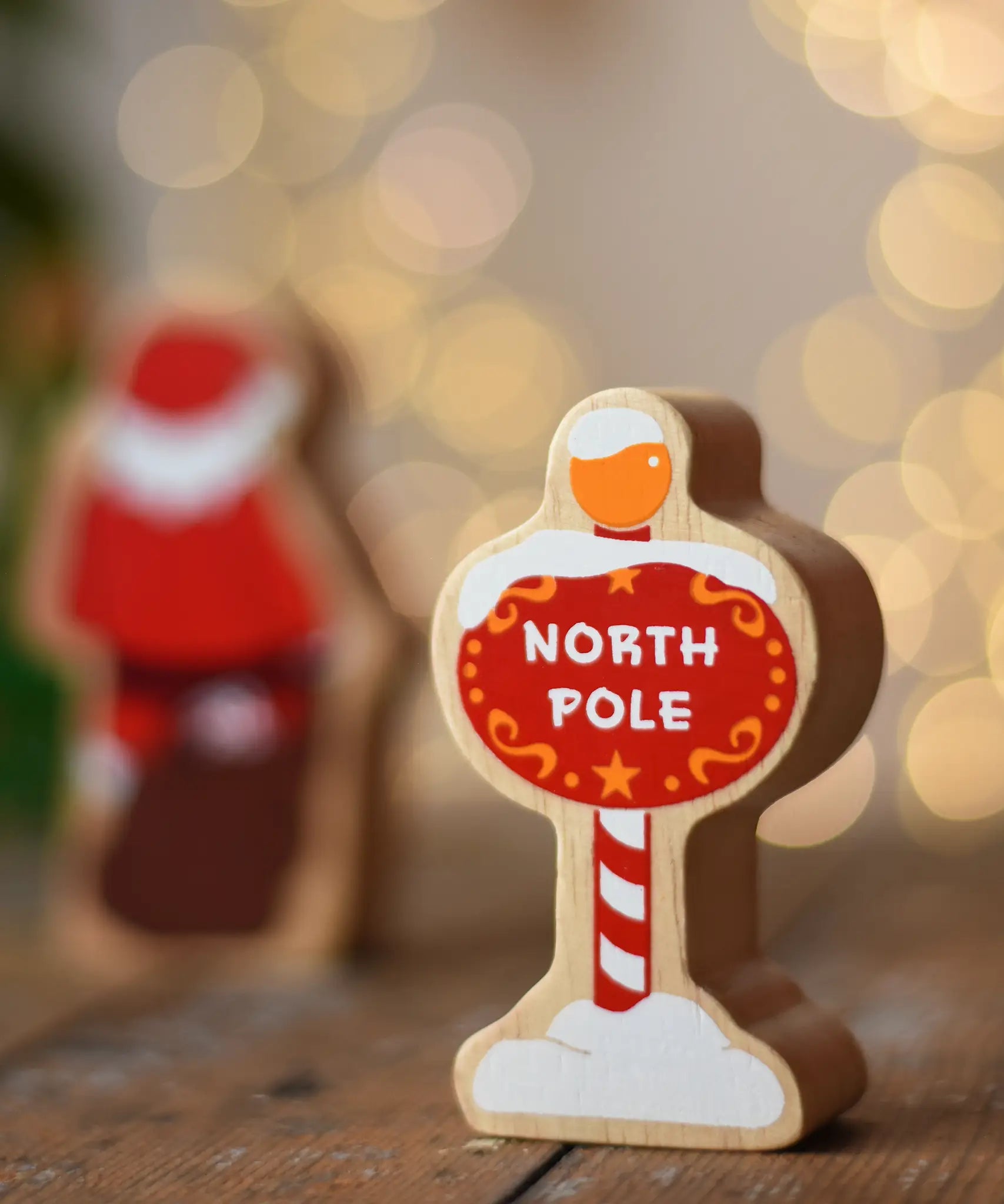 Lanka Kade North Pole sign wooden toy figure. Red snow toped sign with yellow top and striped pole.