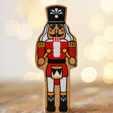 Lanka Kade nutcracker Christmas wooden toy figure placed on a wooden surface in the Babipur playroom.