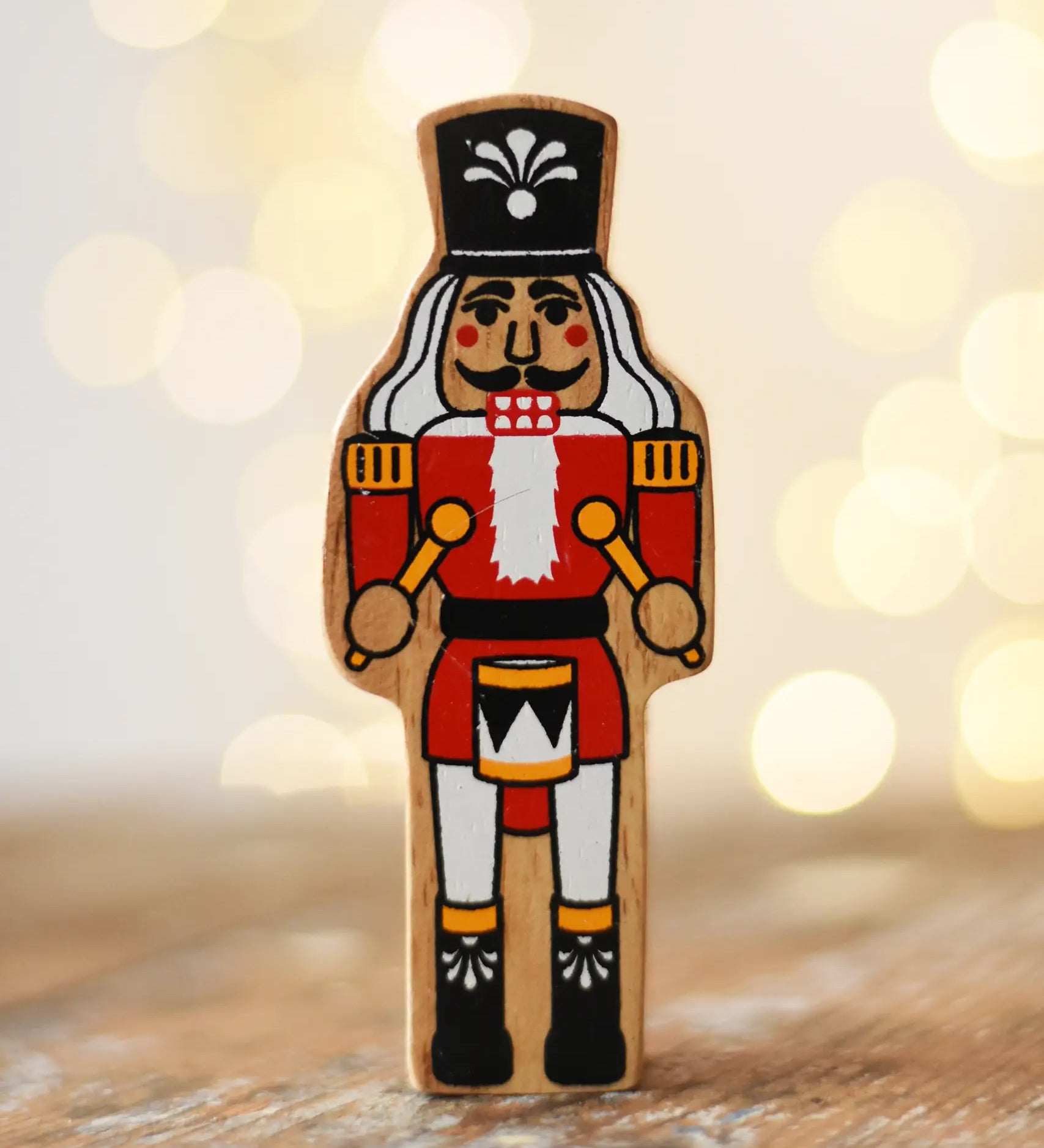 Lanka Kade nutcracker Christmas wooden toy figure placed on a wooden surface in the Babipur playroom.