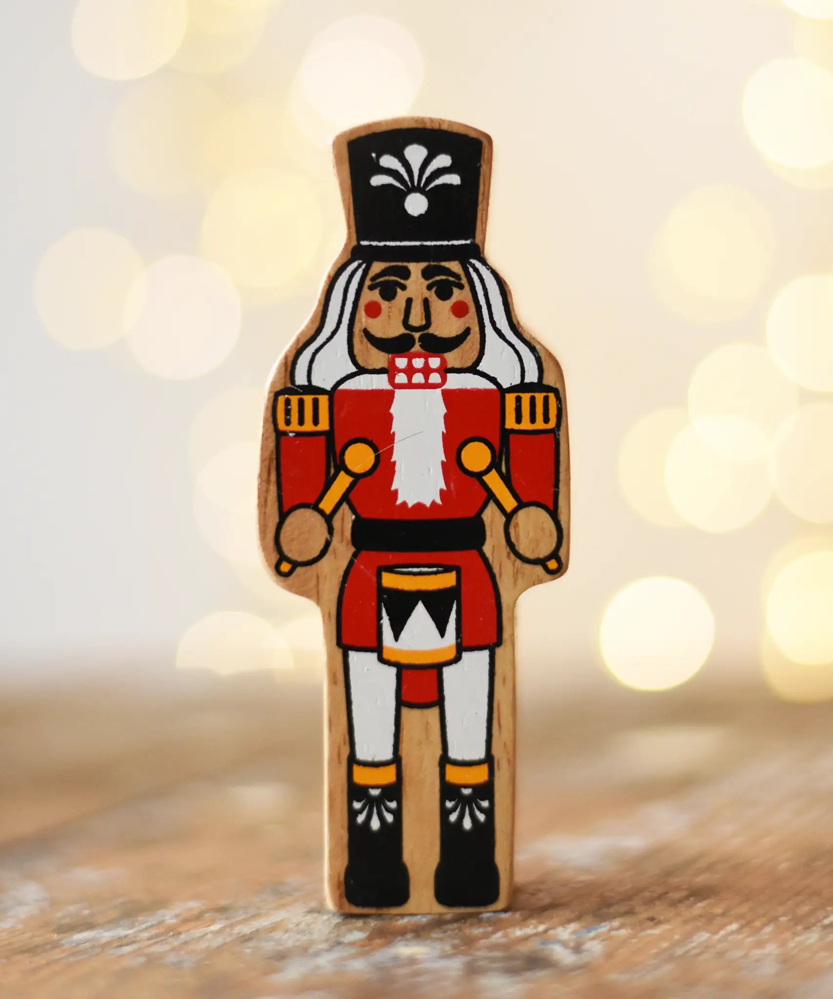 Lanka Kade nutcracker Christmas wooden toy figure placed on a wooden surface in the Babipur playroom.