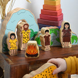A child playing with the Lanka Kade Prehistoric Playset. A play set that contains 8 wooden figure and scenery pieces. These wooden toy figures are part of a huge range of Lanka Kade fair trade, wooden toys available here at Babipur.