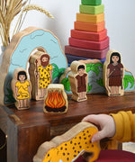 A child playing with the Lanka Kade Prehistoric Playset. A play set that contains 8 wooden figure and scenery pieces. These wooden toy figures are part of a huge range of Lanka Kade fair trade, wooden toys available here at Babipur.