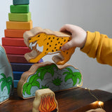 A child playing with the sabre tooth tiger from the Lanka Kade Prehistoric Playset. A play set that contains 8 wooden figure and scenery pieces. These wooden toy figures are part of a huge range of Lanka Kade fair trade, wooden toys available here at Babipur.