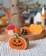 A Lanka Kade Orange Pumpkin placed in front of an Autumn themed celebration ring set up. 
