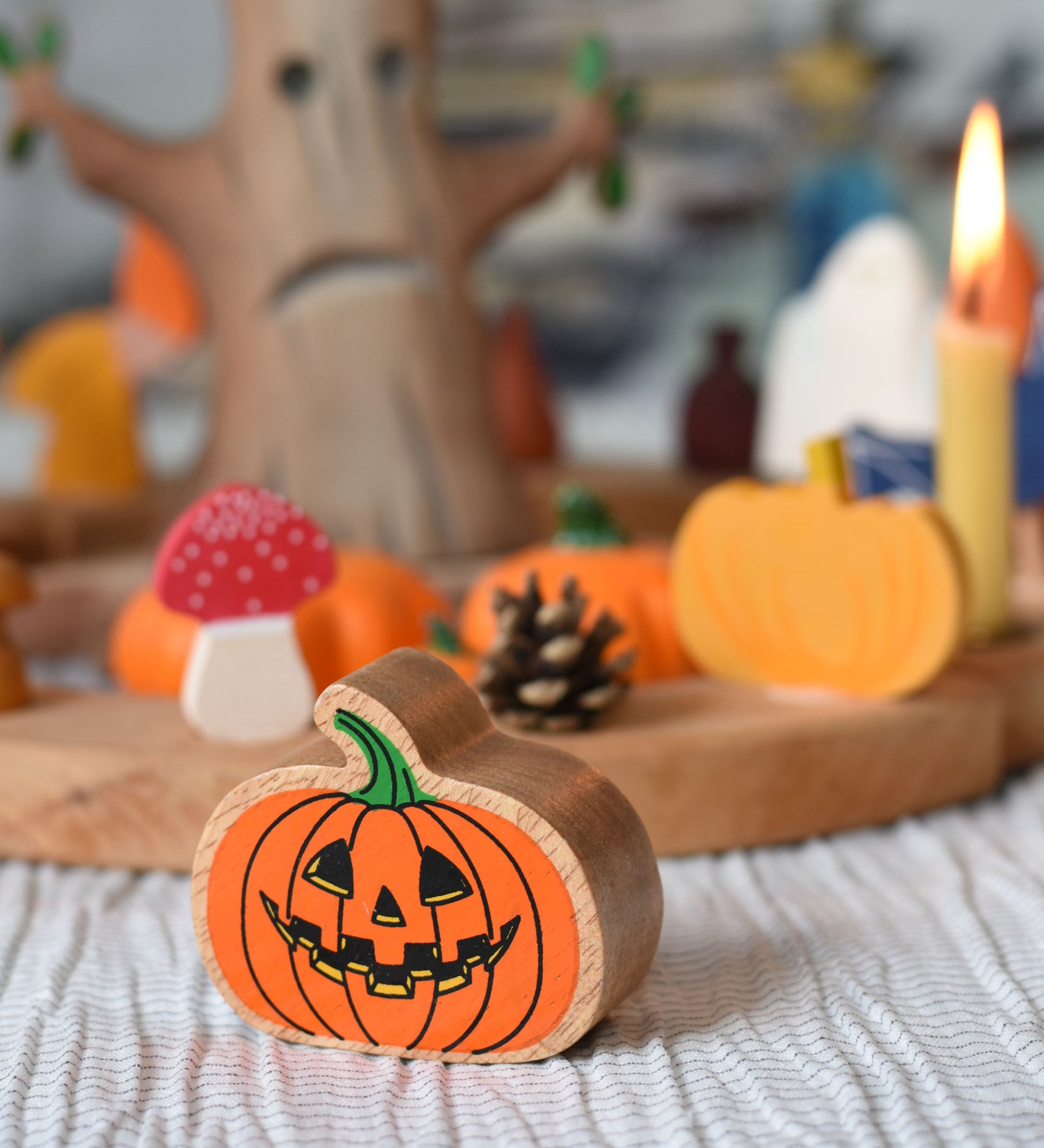 A Lanka Kade Orange Pumpkin placed in front of an Autumn themed celebration ring set up. 