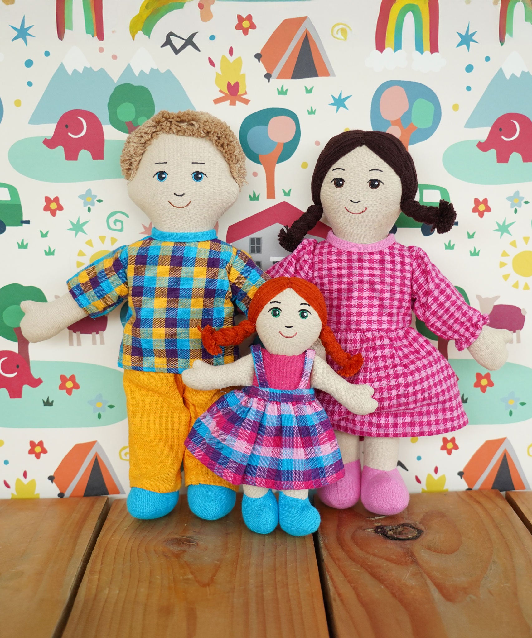 A Lanka Kade Rag Doll Mum with White Skin, Black Hair with Dad with white skin and blond hair and a girl doll with white skin and red hair. 