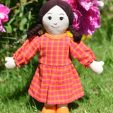 A Lanka Kade Rag Doll Mum with White Skin and Black Hair placed on grass outdoors.