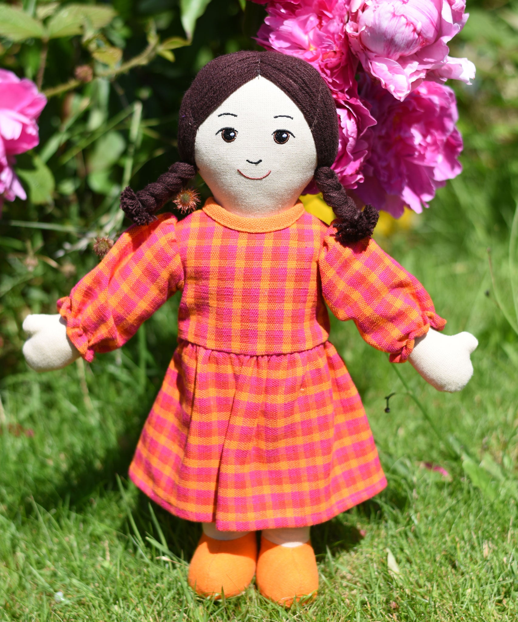 A Lanka Kade Rag Doll Mum with White Skin and Black Hair placed on grass outdoors.