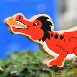 Lanka Kade red dragon wooden toy dragon figure with black details, close up of the dragon's face.