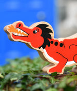 Lanka Kade red dragon wooden toy dragon figure with black details, close up of the dragon's face.