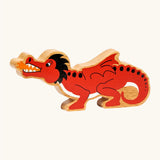 Lanka Kade wooden toy dragon figure in red with black horns and tail details, and small orange accents on the mouth flame and feet