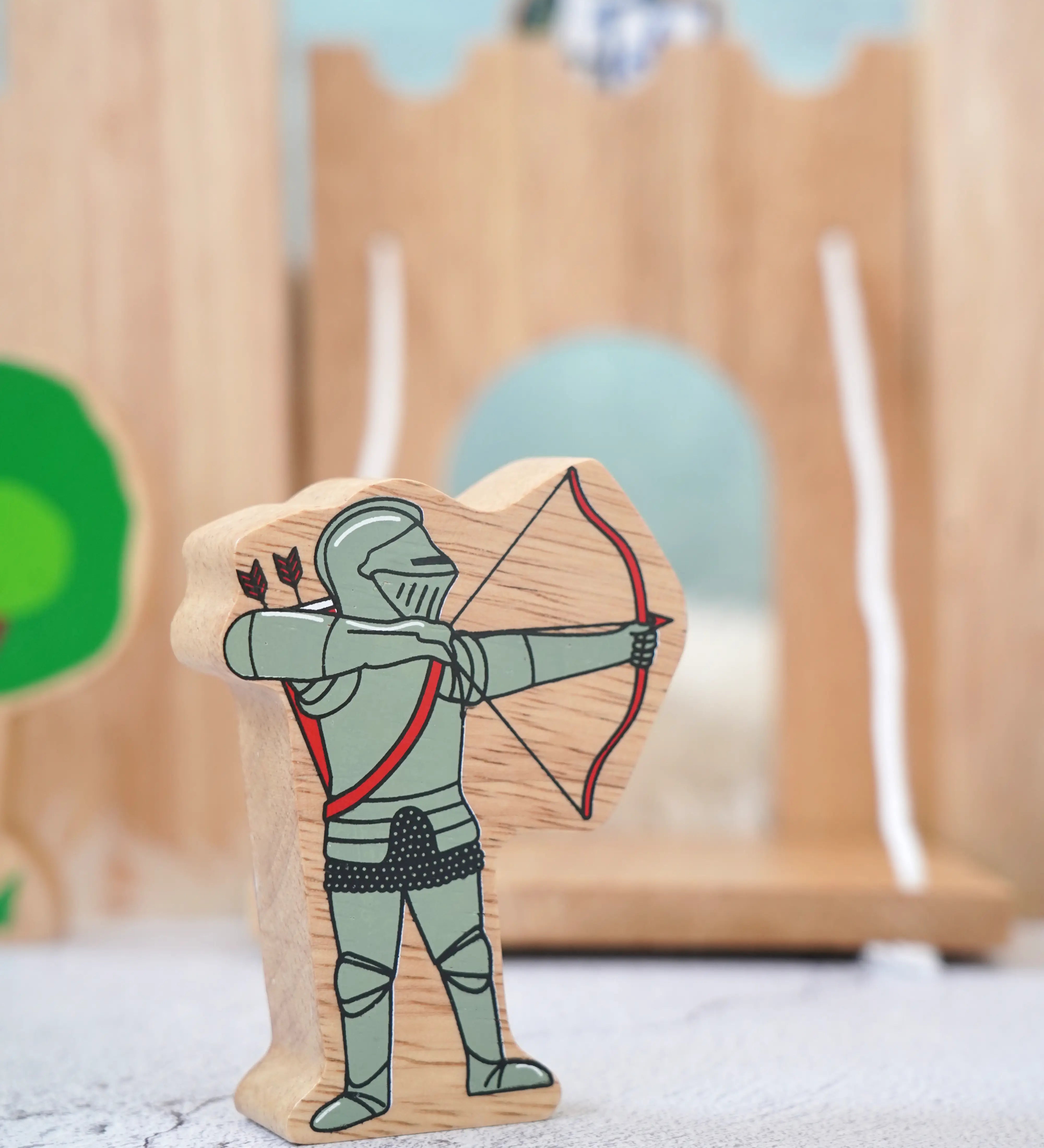 Lanka Kade wooden red armoured knight archer figure with a wooden castle set in the background