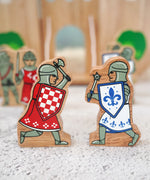 Lanka Kade red foot knight with battle axe wooden figure standing next to a blue knight with morning star weapon fifure
