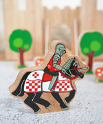 Lanka Kade wooden red knight on horseback figure with a castle and trees figures in the background