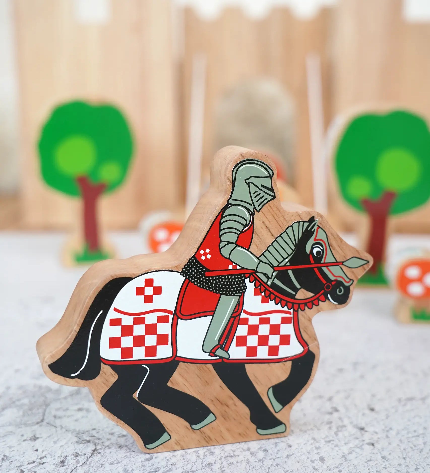 Lanka Kade wooden red knight on horseback figure with a castle and trees figures in the background