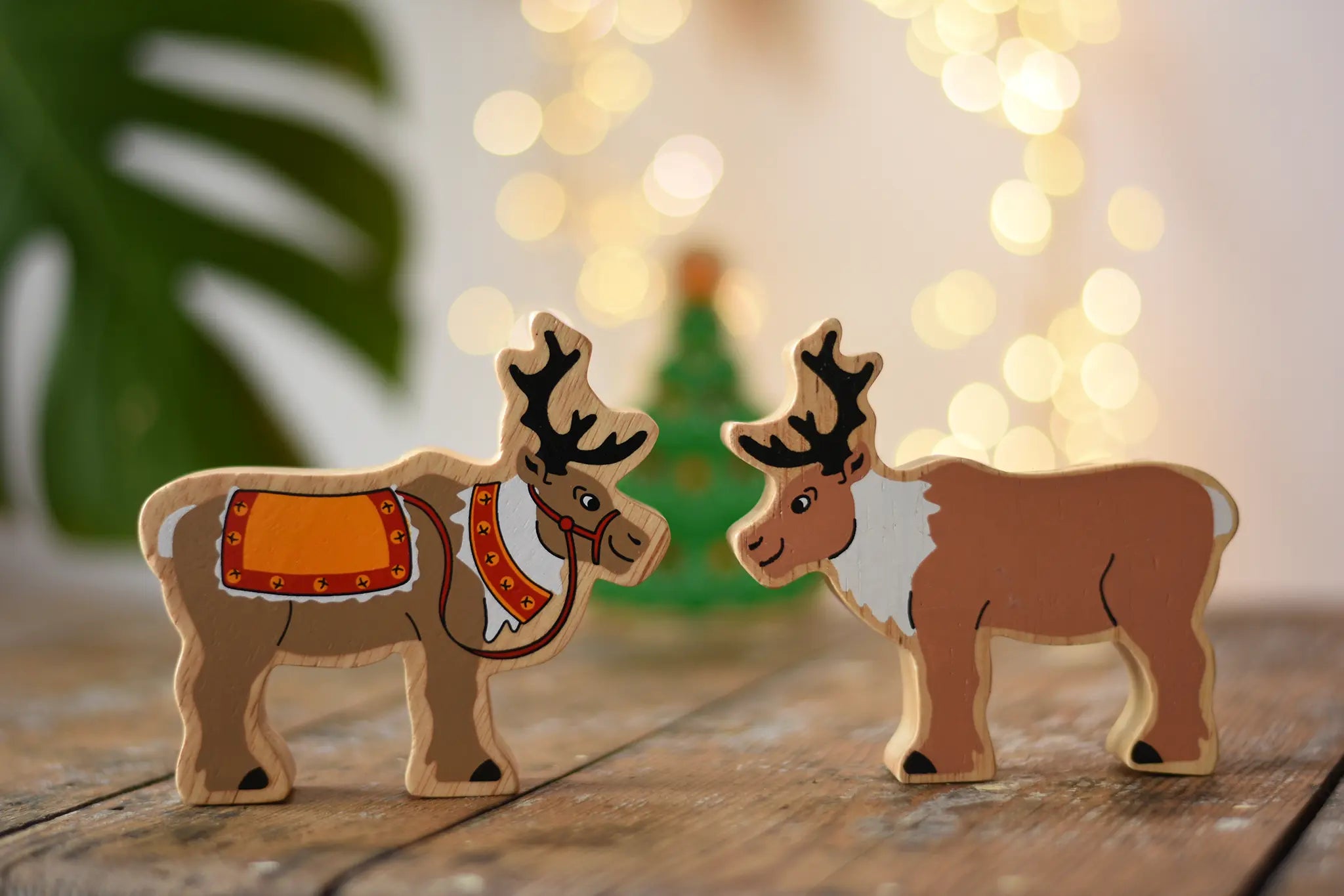 Lanka Kade reindeer wooden toy figures. One has red reigns. 