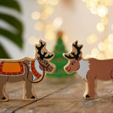 Lanka Kade reindeer wooden toy figures. One has red reigns. 