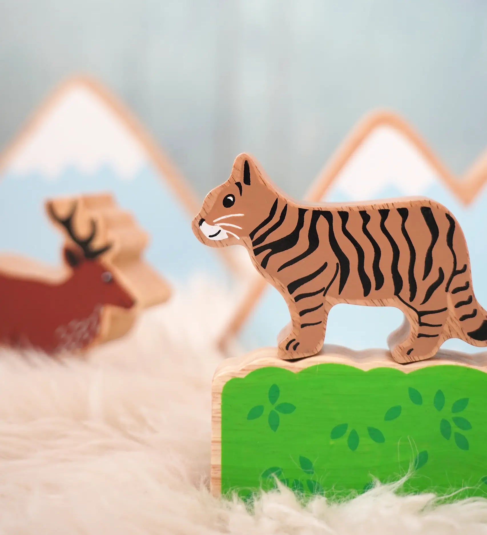 Lanka Kade wooden Scottish wild cat figure standing on a wooden bush with a stag figure in the background