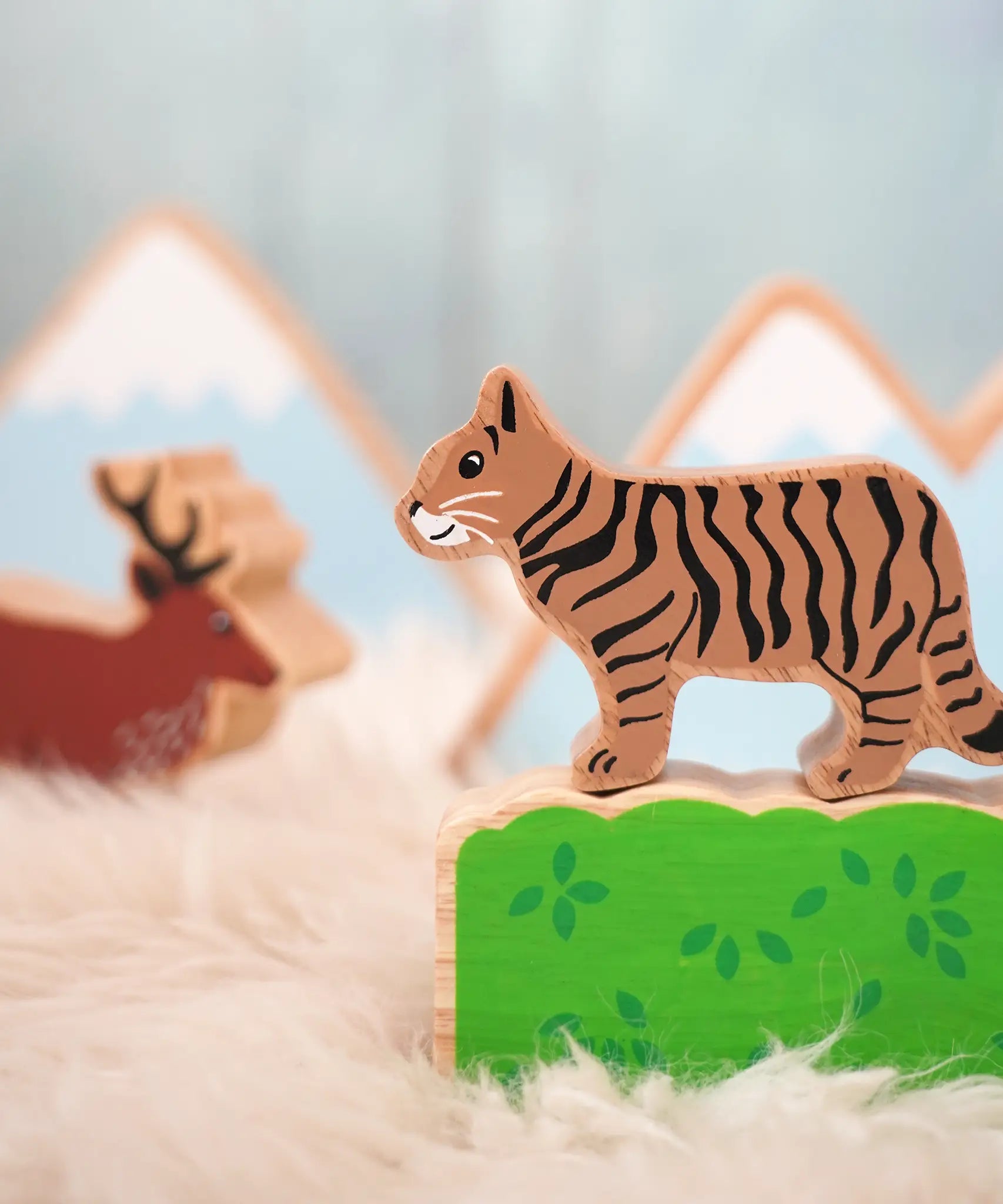 Lanka Kade wooden Scottish wild cat figure standing on a wooden bush with a stag figure in the background