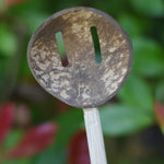 A close up of the front of a slotted spoon from the range of coconut shell utensils from  Lanka Kade. 